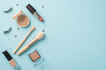 Makeup concept. Top view photo of false eyelashes lipstick makeup brushes eyeshadow nail polish and...