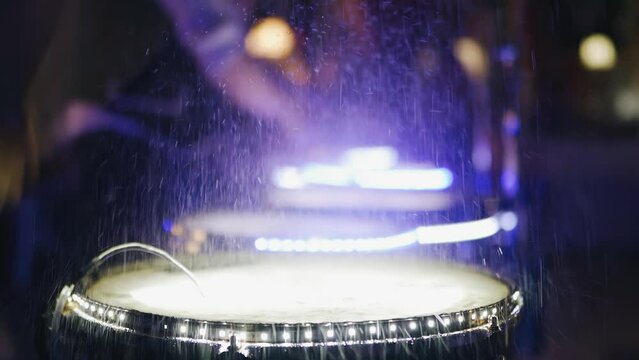Super cool shots of splashes flying from the drum on which the drummer is playing. The footage was shot in slow motion
