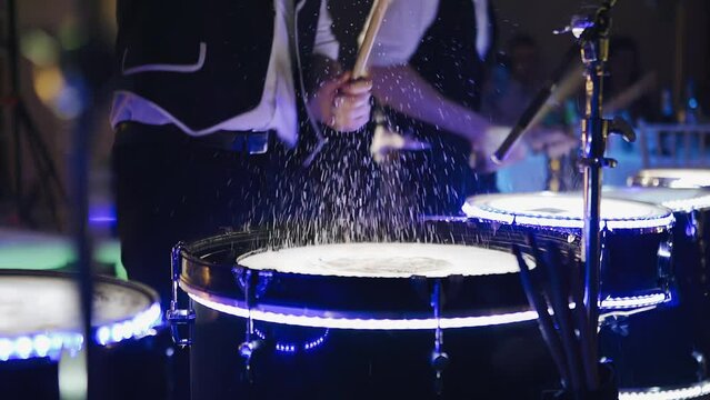 Splashes of water fly up from the blows on the wet drum. Cool slow-motion footage from the drum show