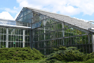 Palmiarnia building in the Park Wilsona, Poznan. Beautiful glass house in the city. Greenhouse with plants inside. - Powered by Adobe