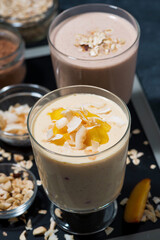 milk cocktail with mango and chocolate in glasses, vertical top view