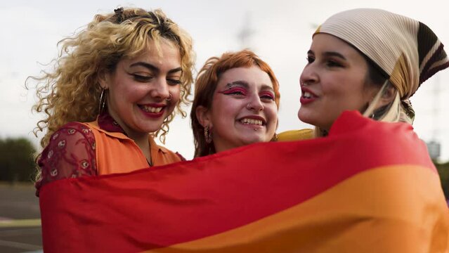 Happy young girls celebrating gay pride festival - LGBT community concept 