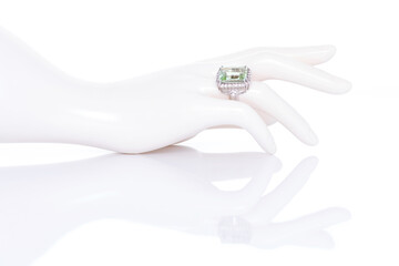 Aquamarine with diamonds ring on plastic mannequin female hand. Collection of natural gemstones accessories. Studio shot
