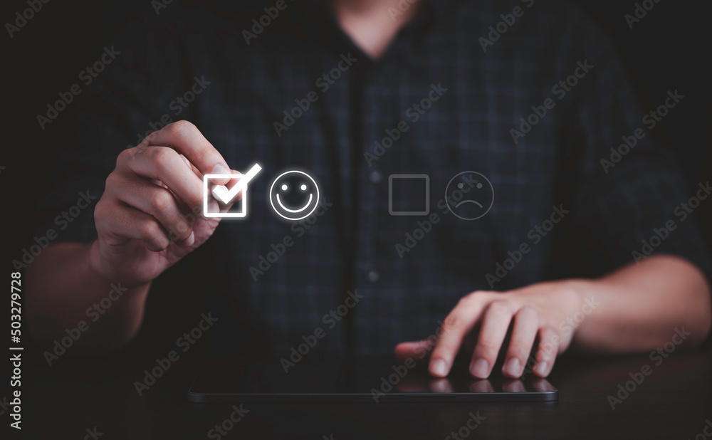 Aufkleber Businessman use pen to tick mark on smile face for client evaluation and customer satisfaction after use product and service concept.