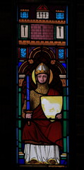 Fototapeta premium Amsterdam Posthoornkerk Church Stained Glass Window Depicting a Sitting Knight Holding a Sword and a Shield with a Lion Close Up, Netherlands