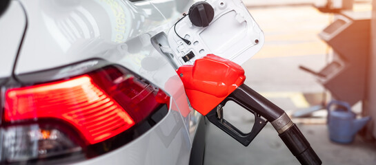 refuel to car, gasoline fuel nozzle in vehicle at petrol station. Oil Price, petroleum economy,...