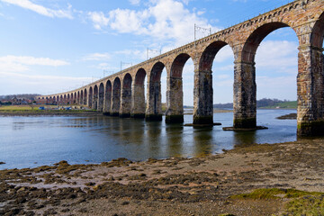 The Royal Border Bridge across the River Tweed at low tide.