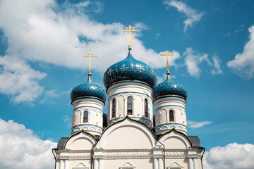 Fototapeta na wymiar The domes of the temple of the Holy Righteous Warrior Admiral Fyodor Ushakov on a clear sunny day against the blue sky. Sights of Russia. Architecture of World Tourism.