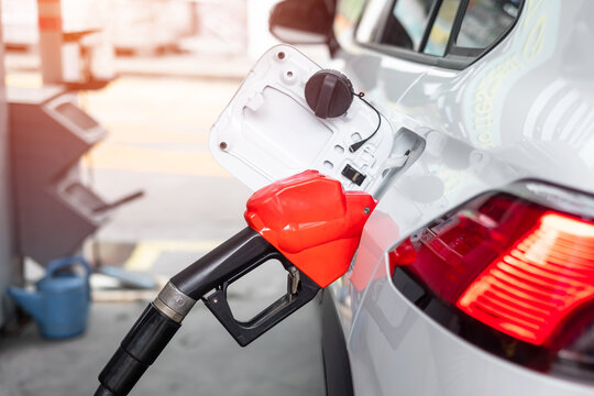 refuel to car, gasoline fuel nozzle in vehicle at petrol station. Oil Price, petroleum economy, inflation and commodity concept