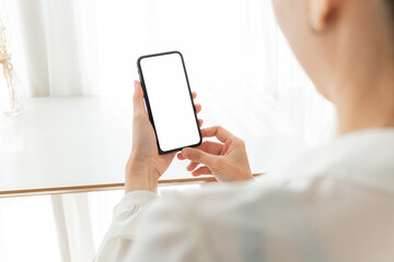 cell phone blank white screen mockup.hand holding texting using mobile on desk at office.background empty space for advertise.work people contact marketing business,technology