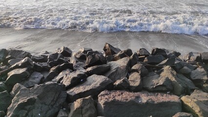 The coast is full of rocks that serve to break the waves in the Pangandaran area, Indonesia