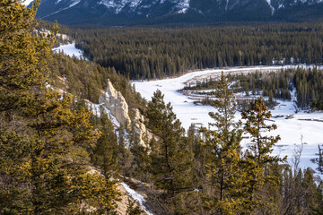 Hoodoos Viewpoint, Banff National Park beautiful landscape. Panorama view Mount Rundle valley forest and frozen Bow River in winter. Canadian Rockies.