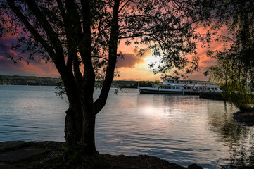 sunset on the lake overlooking a tourist boat