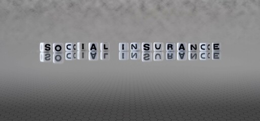 social insurance word or concept represented by black and white letter cubes on a grey horizon background stretching to infinity