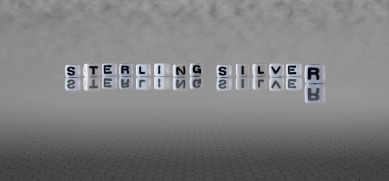 sterling silver word or concept represented by black and white letter cubes on a grey horizon background stretching to infinity