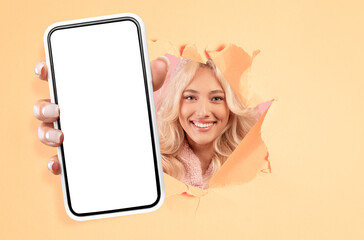 Young lady showing black empty smartphone screen through torn paper