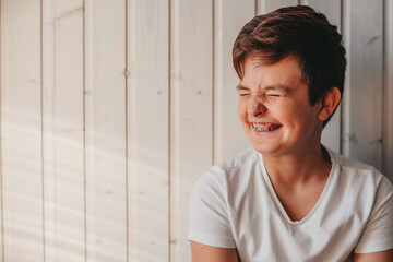 portrait of a teenage boy with a toothy smile 