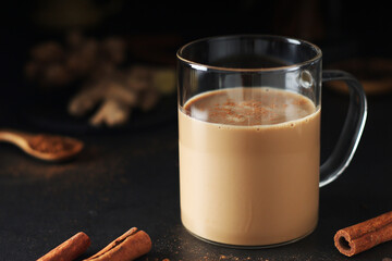 A cup with masala chai in low key