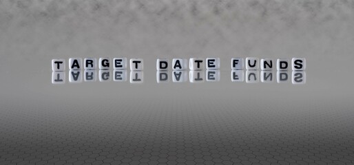 target date funds word or concept represented by black and white letter cubes on a grey horizon...