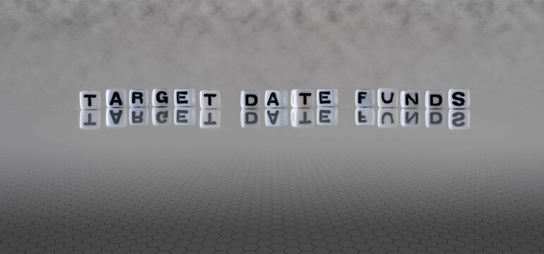 Target Date Funds Word Or Concept Represented By Black And White Letter Cubes On A Grey Horizon Background Stretching To Infinity