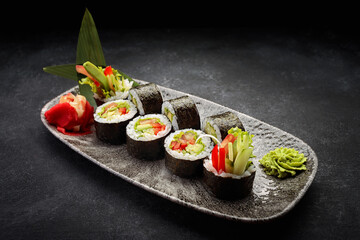 Sushi roll Yasai on a dark plate