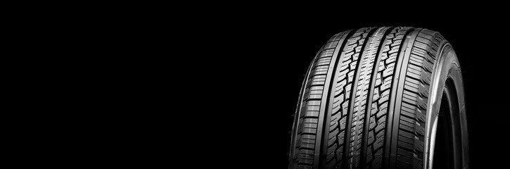 all-season new tire on a black background kopi space panorama auto parts - obrazy, fototapety, plakaty