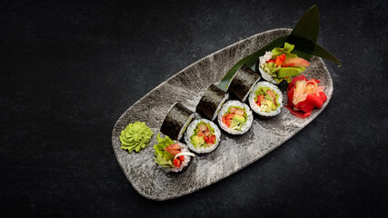 Sushi roll Yasai on a dark plate