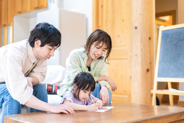Girl and parents studying at home