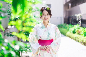 Young woman walking down the street in yukata