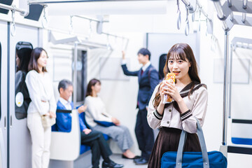 Students eating bread on the train