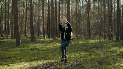 the girl got lost in the forest and is looking for a mobile connection