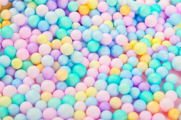 Foam beads of various colors brightly colored abstract background.