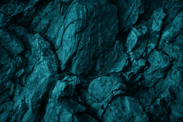 Green blue rock texture. Toned rough mountain surface texture. Crumbled. Close-up. Dark teal rocky background with space for design. Fantasy.  