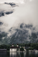 Fototapeta na wymiar Dramatic fog dark mood in the snow covered mountains - Königssee Alps