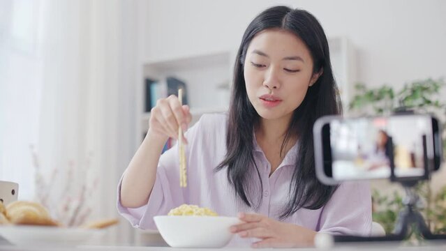 Asian woman streaming eating noodles, mukbang, popular social networks trend