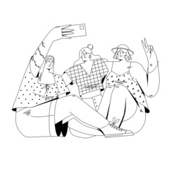 Three girls take a selfie while sitting on the ground.