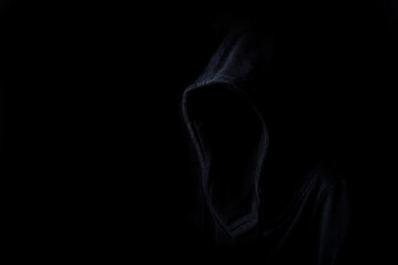 Faces are not visible in black robes in the dark on a black background