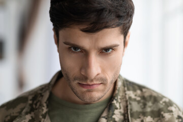 Angry military man looking at camera, closeup shot