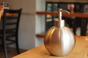 hand wash liquid in a container on cafe table 