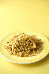 Bombay mix or Chiwda on yellow background 