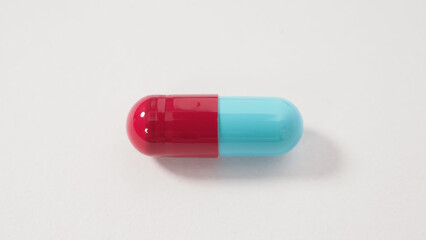 Taking or holding medication pills in hand. Capsule pill on white background isolated. Nitrile disposable gloves and medicines. Drugs healthcare treatment and supplement relieve symptoms of COVID 19.