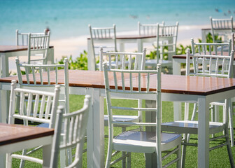 Fototapeta premium Large beach cafe with tables and chairs placed at the sea waterfront