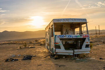 Abandoned RV with a lot of graffiti in the middle of the desert