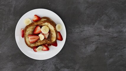 Serving a Plate of French Toast with Strawberries and Bananas
