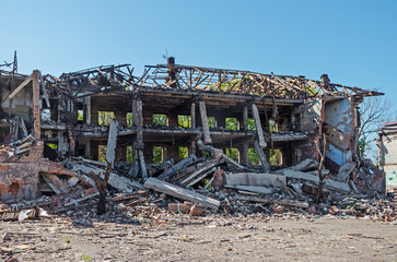 Destroyed brick building of production workshop after aerial bombardment