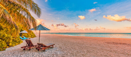Beautiful panoramic nature. Tropical beach sunset as summer island landscape with chairs umbrella...