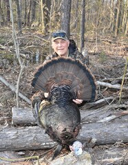 A hunter with a turkey gobbler 