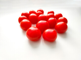 Red cherry tomatoes on white background. Top view.