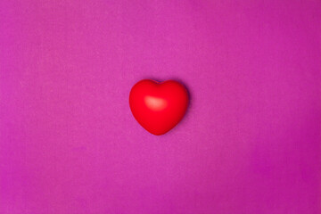 Top view or flat lay of red heart pillow on purple background with copy space, isolated. Valentine's day concept.