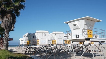 Lifeguard stand and palm tree, life guard tower for surfing on California beach. Summer pacific ocean in USA aesthetic. Iconic rescue baywatch station, coast lifesavers wachtower hut or house by sea.